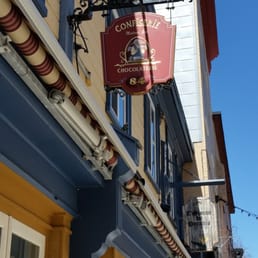 a red sign hanging from the side of a building a red sign hanging from the side of a building
