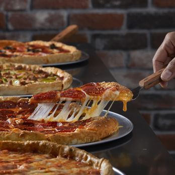 Pizza Inn - a slice of pizza being lifted by a fork - Pizza Near Me - Vicksburg, Mississippi