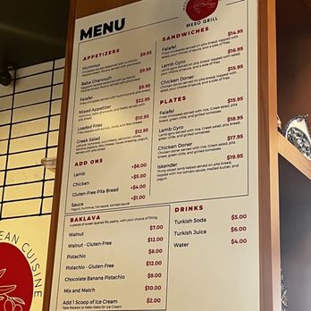 Meso Grill - Menu - Menu board at Meso Grill in Albuquerque lists various food options including appetizers like hummus, baba ghanoush, falafel, and mixed appetizer. It offers sandwiches such as falafel, lamb gyro, chicken doner, and plates including falafel, lamb gyro, chicken doner, and iskender. Additional items include baklava with various fillings and drinks like Turkish soda, Turkish juice, and water. Prices are displayed for each item, with options for add-ons and extra toppings. - Mediterranean Near Me - Albuquerque, New Mexico