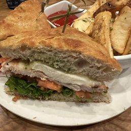 Chicken Caprese Sandwich and potato wedges. Chicken Caprese Sandwich and potato wedges.