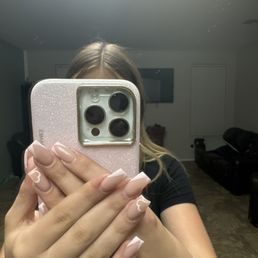 Acrylic nails, pink French tip, with a heart design. Acrylic nails, pink French tip, with a heart design.