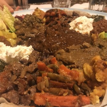 Adey Abeba Ethiopian Restaurant - The meat platter! Piled up two orders of the meat combo on a huge injera - Ethiopian Near Me - Seattle, Washington Adey Abeba Ethiopian Restaurant - The meat platter! Piled up two orders of the meat combo on a huge injera - Ethiopian Near Me - Seattle, Washington