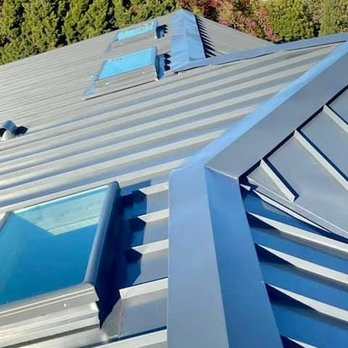 Protecta Roofing - A close-up view of a modern standing seam metal roof, featuring a deep charcoal gray finish, several skylights, and detailed ... - Roofing Near Me - San Marcos, California Protecta Roofing - A close-up view of a modern standing seam metal roof, featuring a deep charcoal gray finish, several skylights, and detailed ... - Roofing Near Me - San Marcos, California