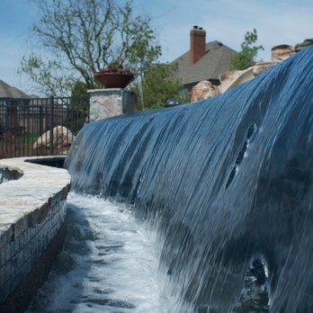 Meadowgreen Group - a small waterfall in a backyard - Landscape Architects or Designers Near Me - Grand Rapids, Michigan Meadowgreen Group - a small waterfall in a backyard - Landscape Architects or Designers Near Me - Grand Rapids, Michigan
