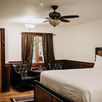 Sylvan Valley Lodge and Cellars - a bed in a room with a ceiling fan - Venues & Event Spaces Near Me - Sautee Nacoochee, Georgia Sylvan Valley Lodge and Cellars - a bed in a room with a ceiling fan - Venues & Event Spaces Near Me - Sautee Nacoochee, Georgia