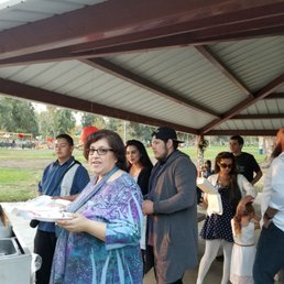 a group of people standing under a shelter