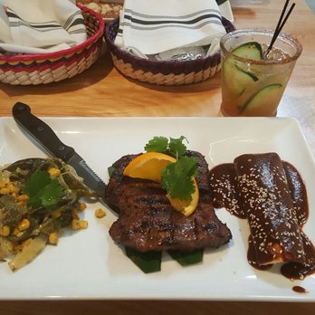 Mesa Mercado - Grilled Flank Steak (Arrachera) with a Chicken Enchilada and the House Mole sauce on top accompanied with some Bell Peppers (rajas) and Corn - Mexican Near Me - Carmichael, California