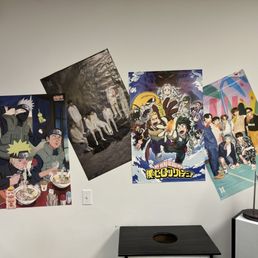 bunch of posters on a wall bunch of posters on a wall