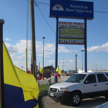 La Sazon Colombiana - Colombian flags in the entrance and the sign. - Colombian Near Me - Houston, Texas