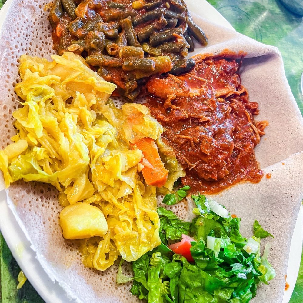Cafe Desta - Individual plate with Fosolia (green beans), Tikil - Gomen (cabbage, potatoes, carrots), and Kaye Doro (berbere chicken) - Coffee & Tea Near Me - Tucson, Arizona