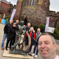 Fab 4 Taxi Tours - This is our tour guide John taking a picture of us with John Lennon artwork in front of the Penny Lane church.