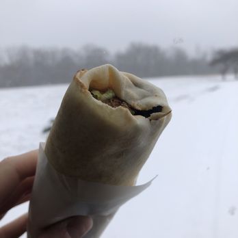 New Yasmeen Bakery - a person holding a burrito in the snow - Bakeries Near Me - Dearborn, Michigan