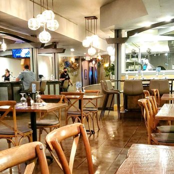 MOSAIC Restaurant - a restaurant with wooden tables and chairs - New American Near Me - Richmond, Virginia