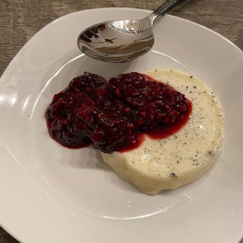 Italy From Scratch - a white plate with cranberry sauce and a spoon - Cooking Classes Near Me Italy From Scratch - a white plate with cranberry sauce and a spoon - Cooking Classes Near Me