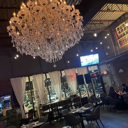 Farsi Kitchen - Industrial lofty urban chic decor with hanging Crystal chandelier as central focal point
