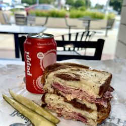 Central Liquor & Deli - Stacked high with corned beef, Swiss, sauerkraut & house dressing on toasted rye -- our Reuben is a Coronado favorite!