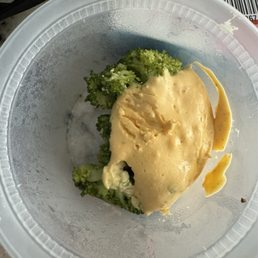 Gelatinous cheese substance on mushy broccoli.