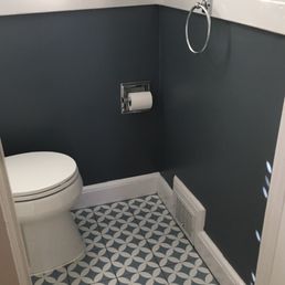a white toilet in a blue and white bathroom a white toilet in a blue and white bathroom