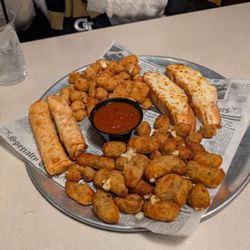 Capones - The cheese platter sampler. The egg rolls are hand made mozzarella sticks. Two types of cheese curds- garlic bread and dill pickle flavored.