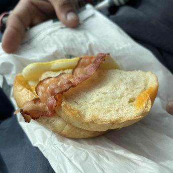Starbucks - a person holding a sandwich with bacon on it - Coffee & Tea Near Me - Delafield, Wisconsin