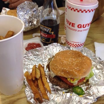 Five Guys - My cheeseburger with jalapeños falling out! My mouth was on fire! The Cajun fries are yummy! - Burgers Near Me - Valencia, California