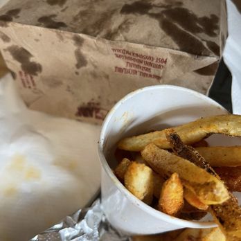 Five Guys - Cajun fries. Note the greasy bag and napkins. - Burgers Near Me - Bridgeton, Missouri