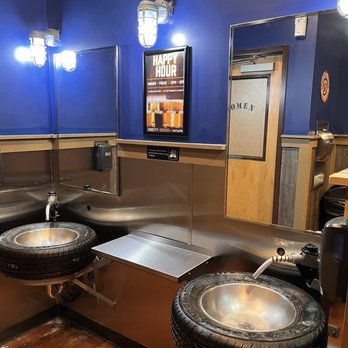 Ford's Garage Dearborn - sinks in the men's room showing the unique tire sinks and gas pump handled water spouts. - Burgers Near Me - Dearborn, Michigan