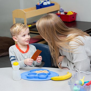 Blue Bird Day - Speech therapist and child working on feeding therapy. - Occupational Therapy Near Me - Chicago, Illinois Blue Bird Day - Speech therapist and child working on feeding therapy. - Occupational Therapy Near Me - Chicago, Illinois