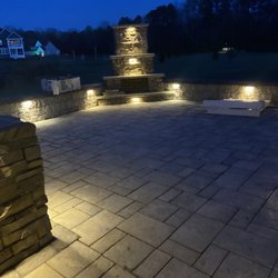 East Coast Landscaping - Raised paver patio with lighting.