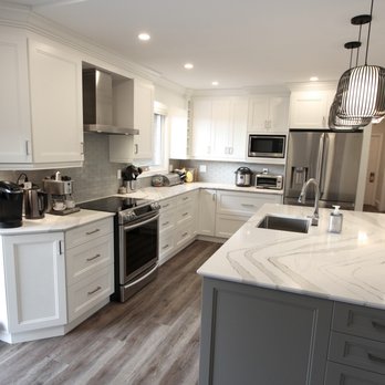 Classic Kitchens & Renovations - a kitchen with white cabinets and marble countertops - General Contractors Near Me - Oshawa, Ontario Classic Kitchens & Renovations - a kitchen with white cabinets and marble countertops - General Contractors Near Me - Oshawa, Ontario