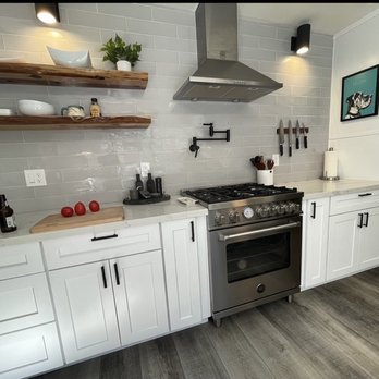 Eco Kitchens - a modern kitchen with white cabinets and stainless steel appliances - General Contractors Near Me - Auburn, California Eco Kitchens - a modern kitchen with white cabinets and stainless steel appliances - General Contractors Near Me - Auburn, California