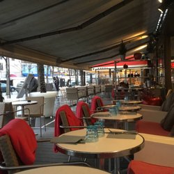 Outside seating with blankets pillows and heating lamps