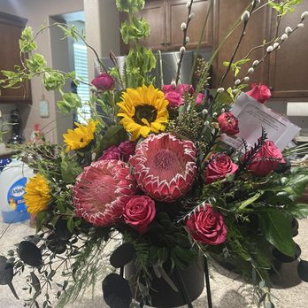 All Seasons Florist - Beautiful fresh arrangement with protea, roses, ranunculus, greenery and willow. Gorgeous keepsake container. - Florists Near Me - Bakersfield, California