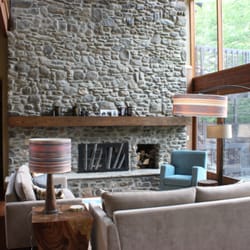 Remarkable Home - Stowe Craft - Susan Bayer-Fishman created a cozy conversation area in front of this massive stone fireplace.