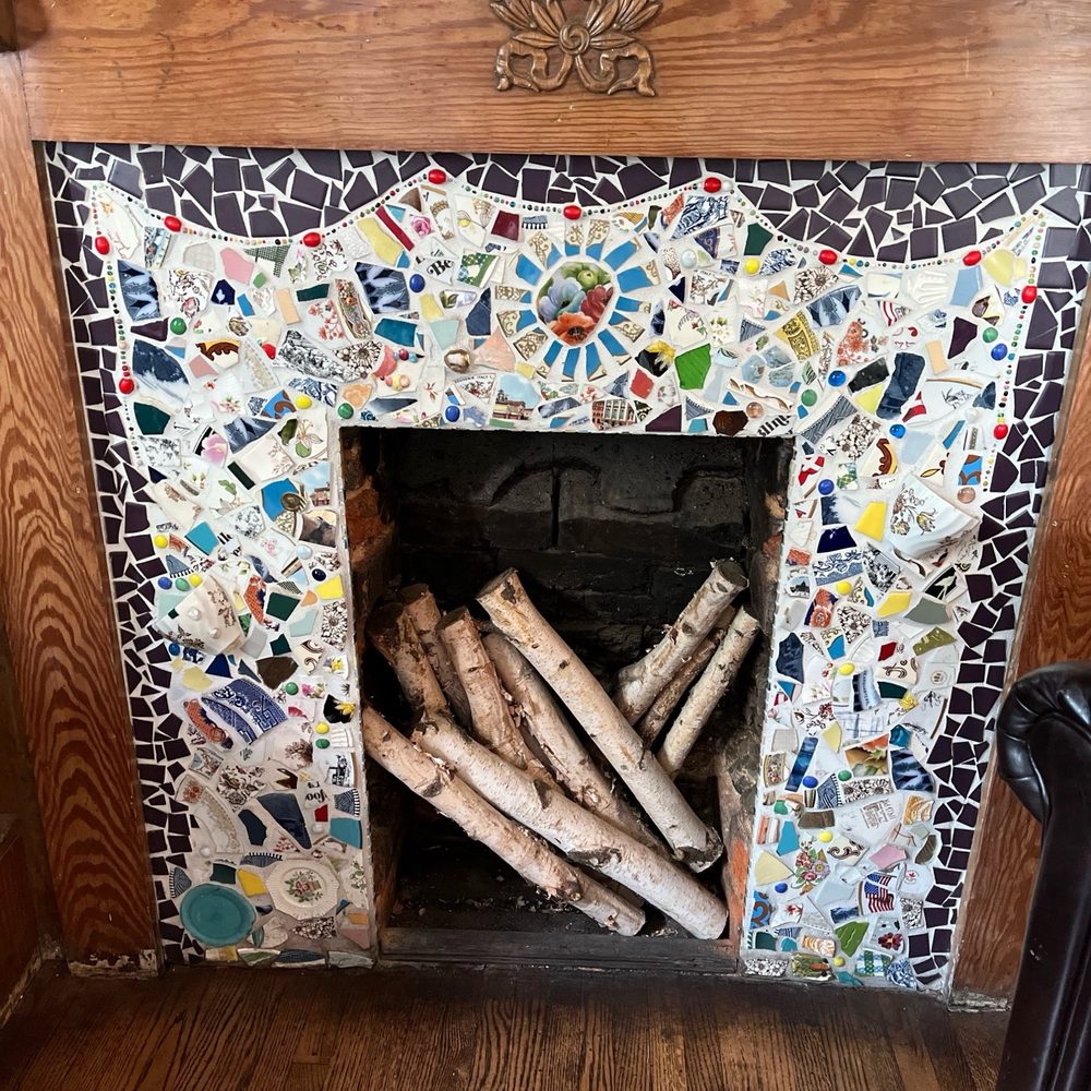 Brakeman's Coffee & Supply - The sitting area in the main room of the shop has a beautiful mosaic fireplace. - Coffee & Tea Near Me - Matthews, North Carolina