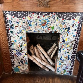 Brakeman's Coffee & Supply - The sitting area in the main room of the shop has a beautiful mosaic fireplace. - Coffee & Tea Near Me - Matthews, North Carolina