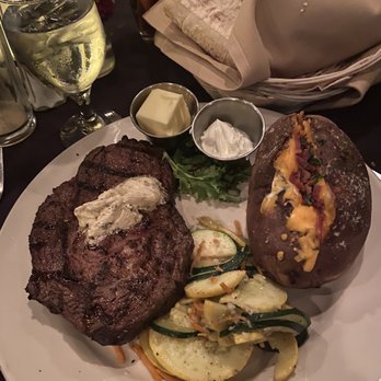 Daniella's Steakhouse - Delmonico steak with loaded baked potato - Steakhouses Near Me - Syracuse, New York