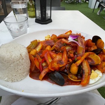 CVI.CHE 105 - "corvina a la chorrillana" -- this was a piece of fish that was pan seared and surrounded by shrimp, mussels, clams, and a lot of onions. - Peruvian Near Me - Miami, Florida CVI.CHE 105 - "corvina a la chorrillana" -- this was a piece of fish that was pan seared and surrounded by shrimp, mussels, clams, and a lot of onions. - Peruvian Near Me - Miami, Florida