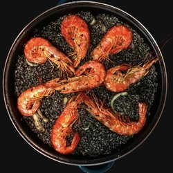 Saffron Paella World - Arroz Negro:
Squid ink paella with prawns and squid