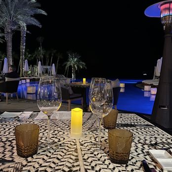 Vela - Outdoor seating facing the infinity pool looks like paradise. - Italian Near Me - Cabo San Lucas, BCS Vela - Outdoor seating facing the infinity pool looks like paradise. - Italian Near Me - Cabo San Lucas, BCS