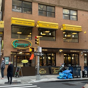 George's - a group of people standing outside of a restaurant - American Near Me - New York, New York