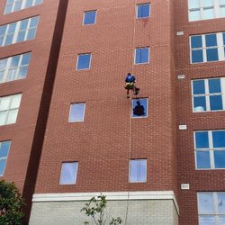 Aces Services - One of our most experienced employees, Colin, repels down the side of a building to make sure each and every window is spotless.