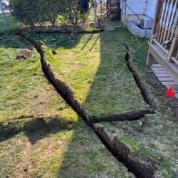 Precision Sprinklers & Outdoor Lighting - BEFORE--underground lines to the left of the deck. Flag marks future location of a sprinkler head.