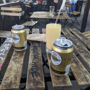 The Johnson's - two cans of beer on a wooden table - Cocktail Bars Near Me - Brooklyn, New York The Johnson's - two cans of beer on a wooden table - Cocktail Bars Near Me - Brooklyn, New York
