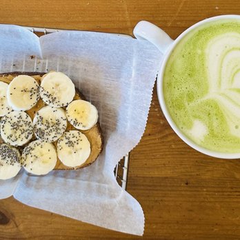 caf bar - Monkey bread and mint matcha latte - Banana toast topped with sliced bananas and chia seeds, served on parchment paper, alongside a mint matcha latte with latte art. - Coffee & Tea Near Me - wakefield, Rhode Island