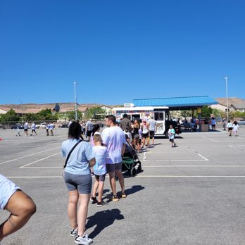UNIT 702 - a group of people standing in a parking lot - Food Trucks Near Me UNIT 702 - a group of people standing in a parking lot - Food Trucks Near Me