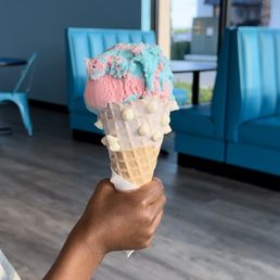 Cotton candy in a white chocolate dipped waffle cone. Cotton candy in a white chocolate dipped waffle cone.