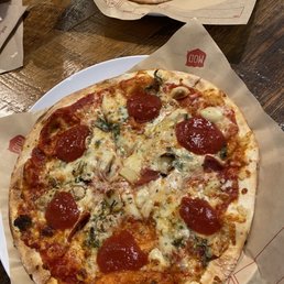 Mod with heavy red sauce, garlic, basil, mozzarella, gorgonzola, light salami, mushroom, roasted garlic, And red sauce dollops.