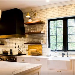 Janet Magliozzi Dba - Darkened stainless steel  kitchen hood vent shroud with brushed brass band accent.
