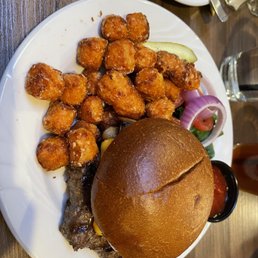 Bison burger with bacon and grilled mushrooms. Side of sweet potato puffs Bison burger with bacon and grilled mushrooms. Side of sweet potato puffs